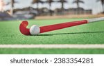 Closeup, hockey and hockey stick with ball on field in sunshine for sport, contest or competition in summer. Sports, turf pitch and artificial grass on ground for exercise, workout and training game