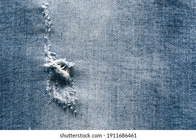 Close-up Of Hole In The Jeans Pants, Texture Background