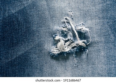 Close-up Of Hole In The Jeans Pants, Texture Background