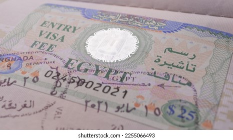 Closeup hologram on an Egyptian visa. Entry Visa fee in Egypt. Egypt visa is affixed to the passport. Entry and exit stamps - Shutterstock ID 2255066493