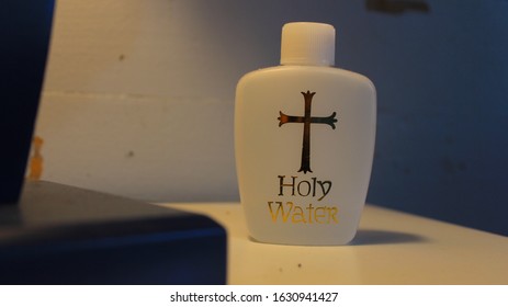 Closeup of holy water on nightstand