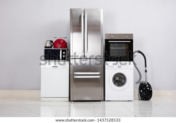 Close-up Of Home Electronic Appliances On Floor\
Against Grey Wall In New\
House