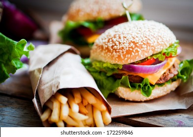 Closeup of home made burgers on wooden background - Shutterstock ID 172259846