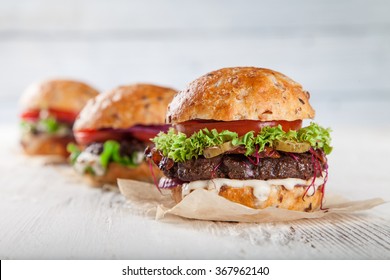 Close-up of home made burgers on wooden background - Powered by Shutterstock