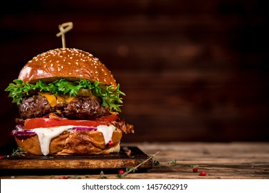 Close-up of home made tasty burger on wooden table.