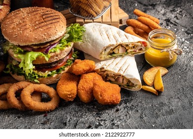 Close-up of home made tasty burger and hot dogs with fried chicken french fries. raditional American food. fast food. - Shutterstock ID 2122922777