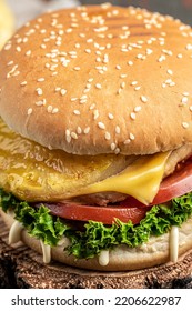 Close-up Of Home Made Tasty Burger With Chicken Cutlet And Pineapple. Street Food. Fast Food And Unhealthy Eating Concept. Vertical Image,