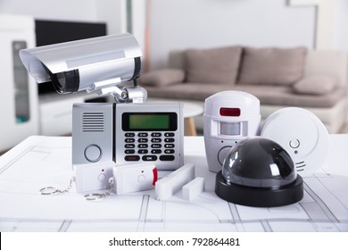 Close-up Of Home Security Equipment On Blueprint