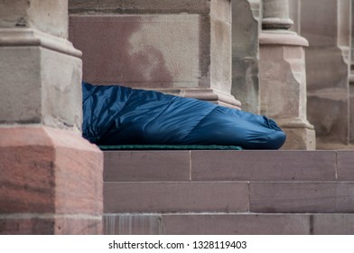 Closeup Of Homeless People Sleeping In The Street In Sleeping Bag 