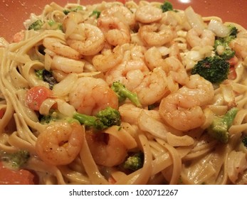 A Close-up Of A Homemade Fettucini Pasta In Alfredo Sauce, With Shrimps, Brocolli And Carrot