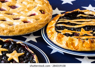 Closeup Of Homemade, Fresh Baked Blueberry Pies And Triple Berry Pie.