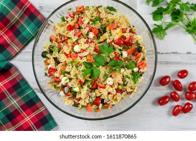 Closeup Of Homemade Pasta Salad With Fresh Vegetables And Herbs On A White Wooden Background