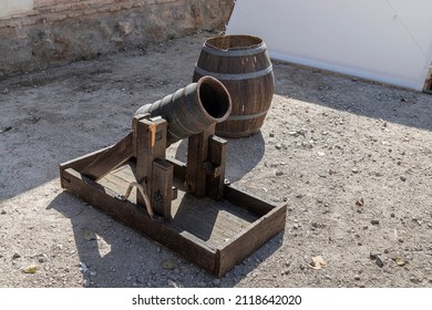 closeup in horizontal view of an ancient medieval mortar cannon and powder keg.outdoors photograph taken in the recreation of a military camp of the XVI century