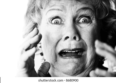 Close-up Of A Horrified Senior Woman With Her Mouth Open.