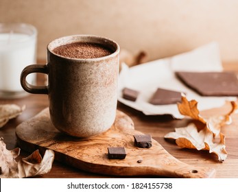 Close-up of hot chocolate in a ceramic mug on the table. Autumn or winter cozy still life. - Powered by Shutterstock