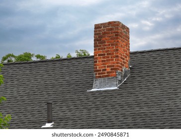 Close-Up of a House Rooftop with Brick Chimney and Vent, Brighton, MA, USA - Powered by Shutterstock