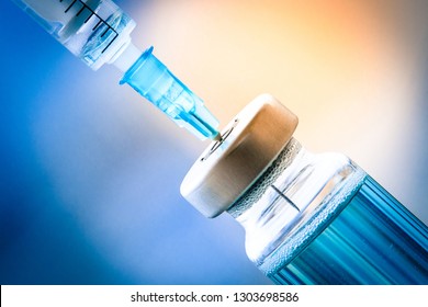 Closeup Of HPV, Flu, Mumps, Measles, Rabies, Pertussis, Diphtheria, Tetanus, Hepatitis, Polio Vaccine Vial Shot With Syringe For Baby, Child, Adult, Pregnant Women In Hospital, Medicine  Drug Concept