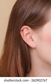 Closeup Human Female Pierced Ear With Earrings