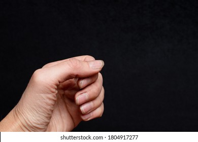 Close-up Of A Human Hand With Nails, Overgrown Cuticles, Flaky Layer And Nail, Bad Manicure On Black Background