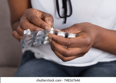 Close-up Of A Human Hand Taking Out Pill From Blister Pack