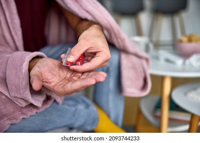 Close-up Of A Human Hand Taking Tablets Out Of A Blister Pack