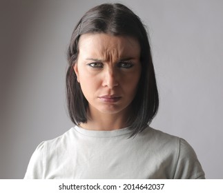 A Closeup Of A Hungarian Brunette Looking Into The Camera With A Confused Gaze And Furrowed Brows