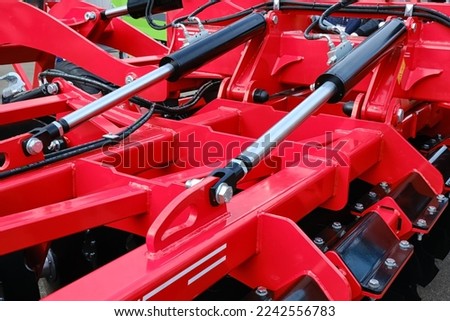 Closeup hydraulic control system of a disc plow for crop processing. Selective focus.