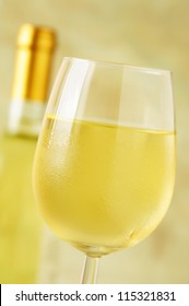 Close-up Of A Ice Cold Glass Of White Wine Covered With Water Drops - Condensation