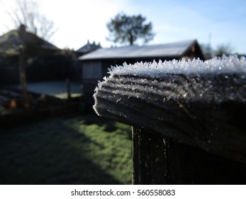 A Closeup Of Ice Crystals On A Fence Post Cap.