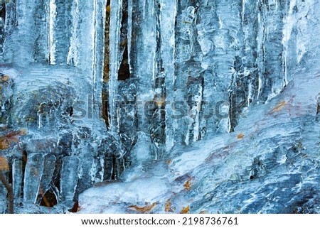 Closeup of ice formations, including long icicles draping the bedrock ledges of Bolton Notch in Bolton, Connecticut.