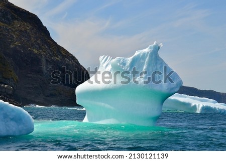 Closeup of iceberg in bay outside St. John's with bright turquoise colouration during Spring