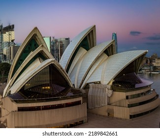 A closeup of iconic world building - Sydney Opera house in full glory at sunset against a colorful sky