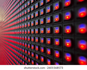 Close-up of an illuminated LED matrix display, showing a grid of red and blue diodes glowing against a dark background, emphasizing digital technology and modern electronics