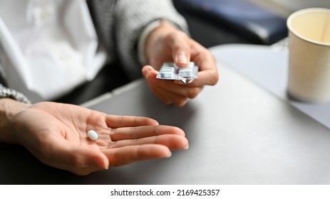 Close-up Image, An Airsick Motion Sickness Pill On A Female Hand. Healthcare And Transportation Concept.