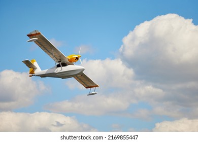 Closeup image of amphibian one-engine airplane at blue sky with clouds background. Aircraft wallpaper. Concept of tourism. - Shutterstock ID 2169855447