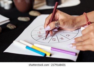 Closeup image of astrologer creating natal card for client to get answer to her question - Shutterstock ID 2179168431