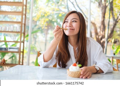 Closeup Image Of A Beautiful Asian Woman Enjoy Eating An Ice Cream In Restaurant