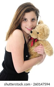 Closeup Image Of A Beautiful Teen Brunette Hugging A Generic Tan Teddy Bear.  On A White Background.