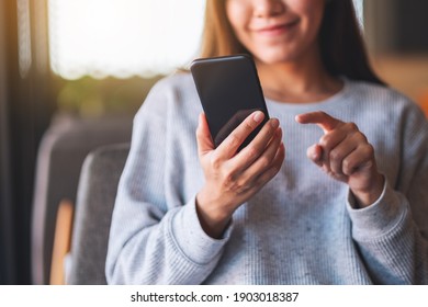 Closeup Image Of A Beautiful Young Asian Woman Holding And Using Mobile Phone