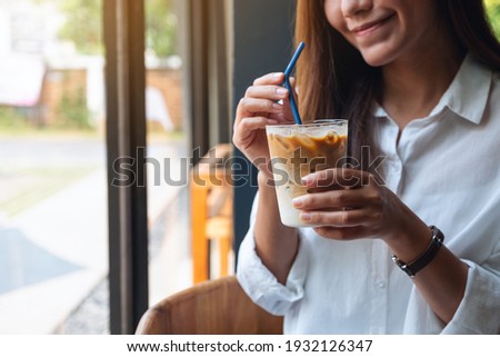 Similar – Image, Stock Photo Hand holding coffee, woman drinking in background