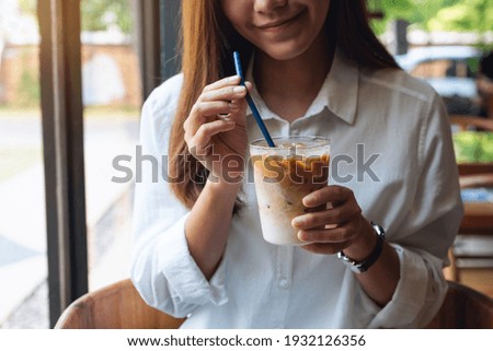 Similar – Image, Stock Photo Hand holding coffee, woman drinking in background