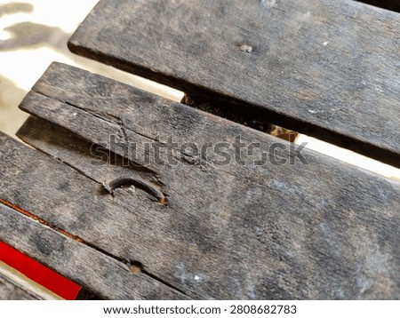 Close-up image of bent nails on old cracked wooden boards