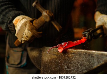 A Close-up Image Of A Blacksmith's Hands Forging A Jewelry Flower From A Hot Sheet Of Metal. Handmade In The Forge Concept