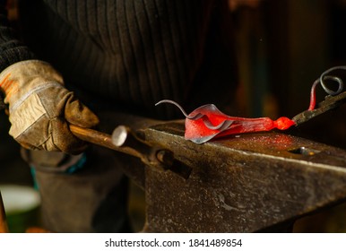 A Close-up Image Of A Blacksmith's Hands Forging A Jewelry Flower From A Hot Sheet Of Metal. Manual Rework In The Forge Concept