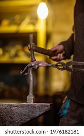 A Close-up Image Of A Blacksmith's Hands Forging A Jewelry Flower From A Hot Sheet Of Metal. Manual Rework In The Forge Concept