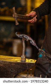 A Close-up Image Of A Blacksmith's Hands Forging A Jewelry Flower From A Hot Sheet Of Metal. Manual Rework In The Forge Concept