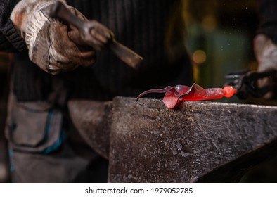 A Close-up Image Of A Blacksmith's Hands Forging A Jewelry Flower From A Hot Sheet Of Metal. Manual Rework In The Forge Concept