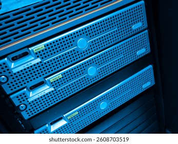 A close-up image of blue-lit server racks located in a modern data center, showcasing advanced technology and efficient storage solutions in a professional IT environment.