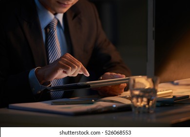 Close-up Image Of Business Person Using Tablet Computer In Dark Office