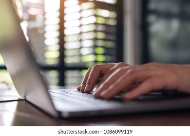 Closeup image of a business woman's hands working and typing on laptop keyboard  - Shutterstock ID 1086099119